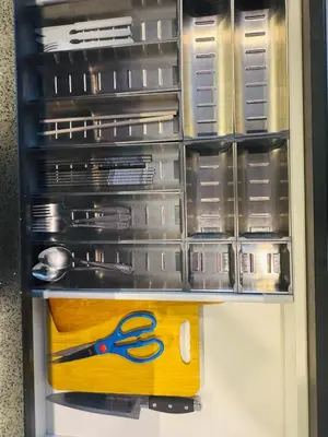 a drawer with scissors and other items in it at Axon Purple Suite Kuala Lampur in Kuala Lumpur