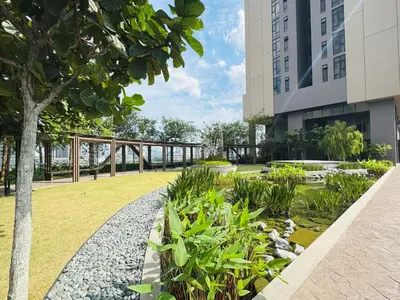 a garden in front of a building at Axon Purple Suite Kuala Lampur in Kuala Lumpur