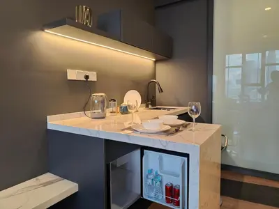 a kitchen with a counter with wine glasses on it at Ceylonz Suites, Bukit Bintang, Kuala Lumpur in Kuala Lumpur