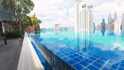 a swimming pool with a view of the city at Luxury Suites Majestic Residences at Heart of KLCC in Kuala Lumpur