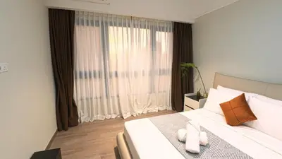 a bedroom with a bed and a large window at Luxury Suites Majestic Residences at Heart of KLCC in Kuala Lumpur
