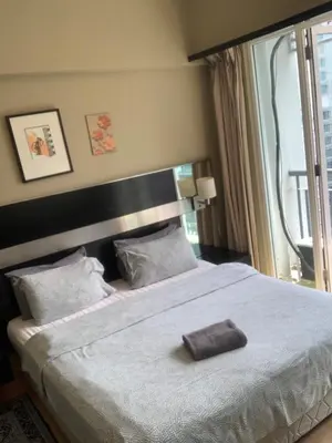 a bedroom with a large bed with a large window at Sweet cozy house by seri bukit Ceylon in Kuala Lumpur