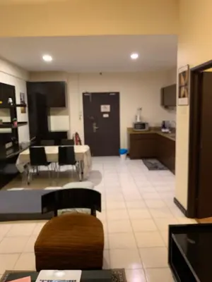 a room with a kitchen and a living room at Sweet cozy house by seri bukit Ceylon in Kuala Lumpur