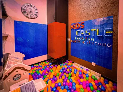 a pile of balls in a room with a clock at KidsCastle Dorsett Pavillion in Kuala Lumpur