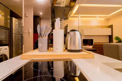a kitchen counter with a cutting board with utensils at KidsCastle Dorsett Pavillion in Kuala Lumpur