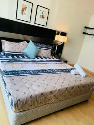 a bedroom with a large bed with a black headboard at seri bukit ceylon by sweet cozy house in Kuala Lumpur
