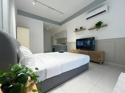 a bedroom with a bed and a flat screen tv at The Majestic Residence By Awesomestay in Kuala Lumpur