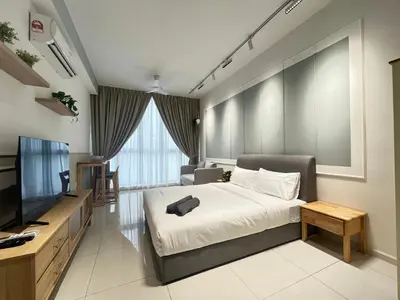 a hotel room with a bed and a television at The Majestic Residence By Awesomestay in Kuala Lumpur
