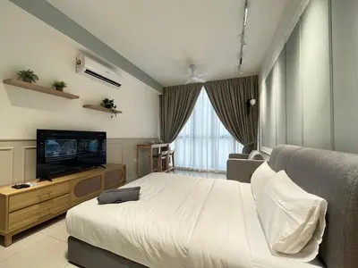a bedroom with a bed and a flat screen tv at The Majestic Residence By Awesomestay in Kuala Lumpur