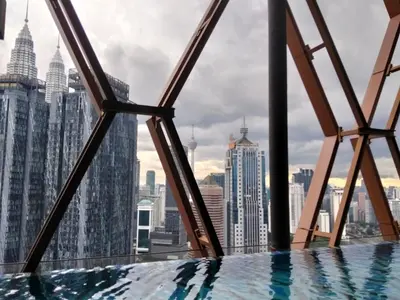 a swimming pool on the top of a skyscraper at Scarletz Service Suites KLCC in Kuala Lumpur