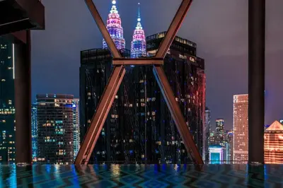 a view of a city skyline at night at Scarletz Service Suites KLCC in Kuala Lumpur