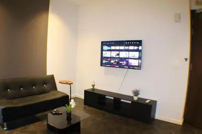 a living room with a couch and a flat screen tv at Hospitality Service Suites Scarlitz KLCC in Kuala Lumpur