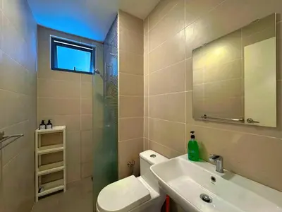 a bathroom with a sink and a toilet and a mirror at 4BR KLCC View MRT 2min Free Parking Big Unit in Kuala Lumpur