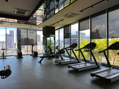 a gym with a bunch of tread machines in a building at 4BR KLCC View MRT 2min Free Parking Big Unit in Kuala Lumpur