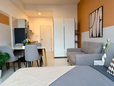 a bedroom with a bed and a table and a couch at The Majestic Residence Suites By Casabellestay in Kuala Lumpur