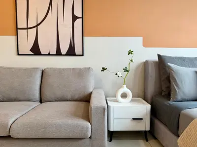 a living room with a couch and a vase on a table at The Majestic Residence Suites By Casabellestay in Kuala Lumpur