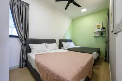 a bedroom with two beds and a ceiling fan at KL City Central TRX 3 Bedrooms 2 Baths & Balcony in Kuala Lumpur