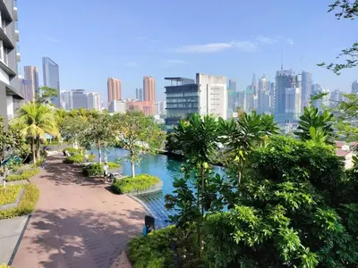 a river with trees and a city in the background at KL City Central TRX 3 Bedrooms 2 Baths & Balcony in Kuala Lumpur
