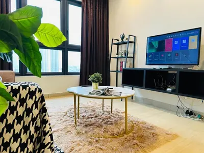 a living room with a coffee table and a tv at MVA19#Family Suite 8 pax 3 Rooms Sunway Velocity Mall, MRT Maluri Cheras in Kuala Lumpur