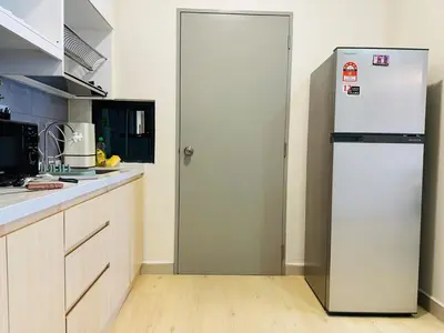 a white refrigerator in a kitchen with a wooden floor at MVA19#Family Suite 8 pax 3 Rooms Sunway Velocity Mall, MRT Maluri Cheras in Kuala Lumpur