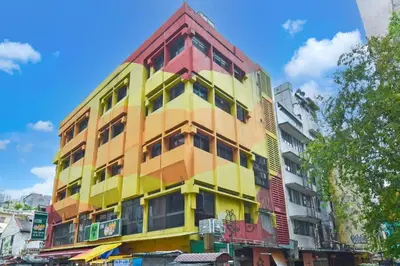 a multicolored building on a city street at Hotel Pollodium Chinatown KL in Kuala Lumpur