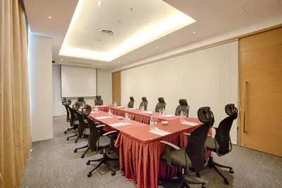 a conference room with a long table and chairs at WP Hotel in Kuala Lumpur
