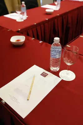 a table with a bottle of water and a glass at WP Hotel in Kuala Lumpur
