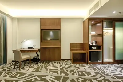 a hotel room with a desk and a television at WP Hotel in Kuala Lumpur