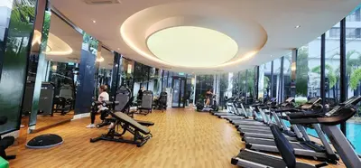 a gym with a lot of treadmills and ellipticals at TRION KL Premier Residence in Kuala Lumpur