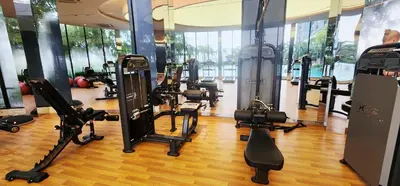 a gym with several treadmills and cardio machines at TRION KL Premier Residence in Kuala Lumpur