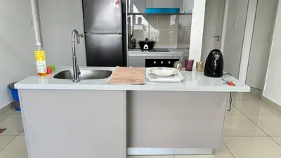 a kitchen counter with a sink and a refrigerator at Comfy 1BR klcc view imperial suite B47 09 Trion KL in Kuala Lumpur