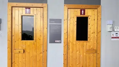 two wooden doors on the side of a building at Couple home Netflix free parking A45 08St Trion KL in Kuala Lumpur