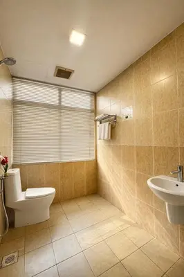 a bathroom with a toilet and a sink at Swiss Hotel at City Centre in Kuala Lumpur