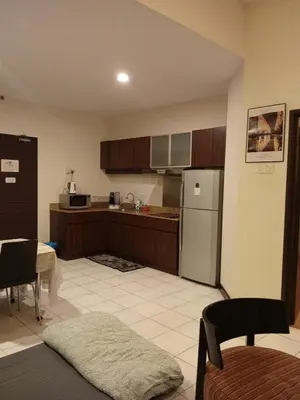 a kitchen with a refrigerator and a table at Seri bukit Ceylon by anhome changkat in Kuala Lumpur