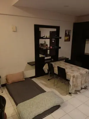 a living room with a table and chairs in it at Seri bukit Ceylon by anhome changkat in Kuala Lumpur