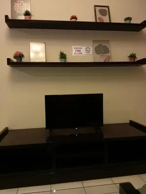 a living room with a flat screen tv on a shelf at Seri bukit Ceylon by anhome changkat in Kuala Lumpur