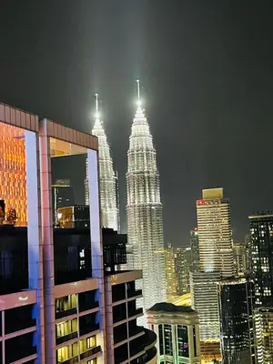 a view of the petronas twin towers at night at The Platinum Suite KL in Kuala Lumpur