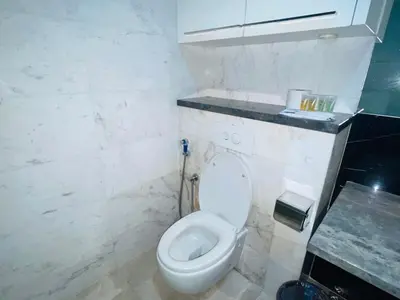 a bathroom with a white toilet and a counter at The Platinum Suite KL in Kuala Lumpur