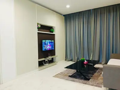 a living room with a couch and a tv at The Platinum Suite KL in Kuala Lumpur