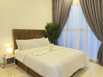 a bedroom with a bed with white sheets and a window at Couple 1BR cozy suite B41 05 Trion KL in Kuala Lumpur