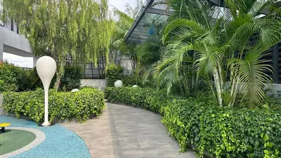 a courtyard with a palm tree in a building at Couple nest A37 10St Trion KL in Kuala Lumpur
