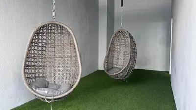 two baskets hanging on a wall with green carpet at Couple nest A37 10St Trion KL in Kuala Lumpur