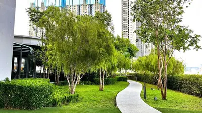 a walkway in a park with trees and buildings at Couple Private studio B22 11 Trion KL in Kuala Lumpur