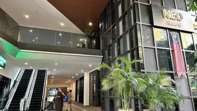 a building with people walking in front of it at Couple Private studio B22 11 Trion KL in Kuala Lumpur