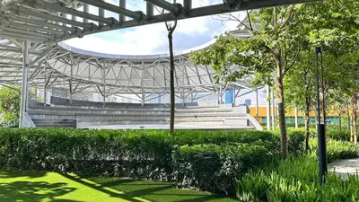 an empty bleachers in a stadium with green grass at Couple Private studio B22 11 Trion KL in Kuala Lumpur
