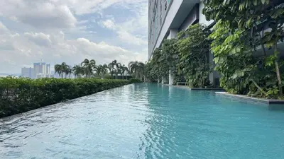 a pool of blue water next to a building at Couple Studio Suite A16 07 Trion KL in Kuala Lumpur