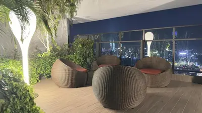 a patio with rattan chairs and a view of the city at Couple Studio Suite A16 07 Trion KL in Kuala Lumpur