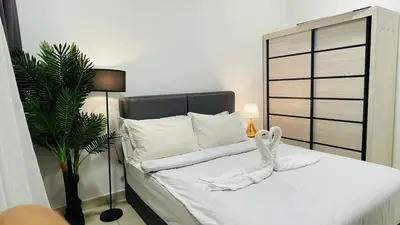 a bedroom with a bed with a white towel on it at Couple Studio Suite A28 07 Trion KL in Kuala Lumpur