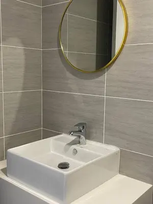 a bathroom with a white sink and a mirror at Couple Studio Suite A28 07 Trion KL in Kuala Lumpur