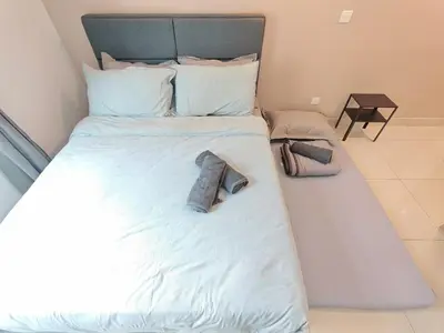 a large white bed with two pillows on it at O 3 Room 200mbps wifi near Mrt Lrt HKL PWTC KLCC in Kuala Lumpur